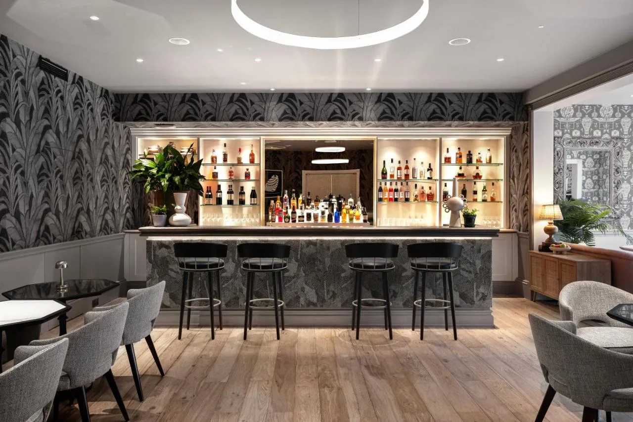 A bar with stools inside the Royal Crescent Hotel & Spa restaurant