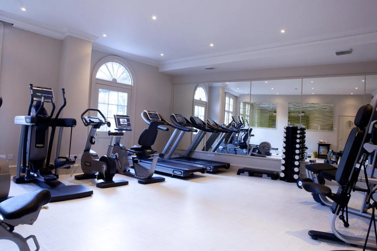 A gym with treadmills and ellipticals at the Royal Crescent Hotel & Spa